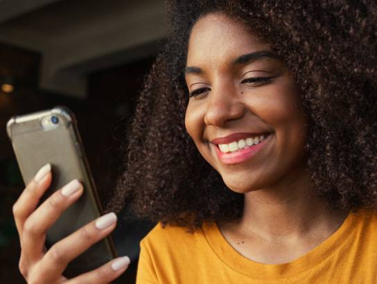 Woman smiling at phone